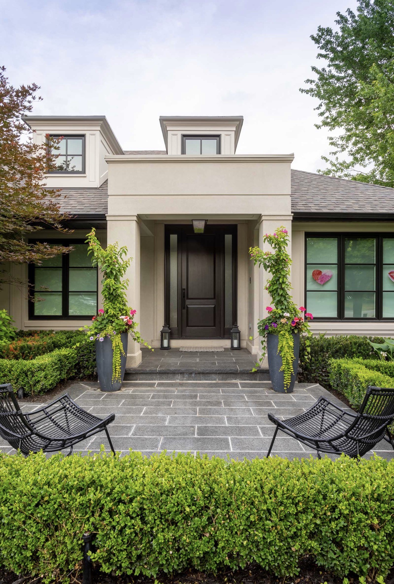 Garden courtyard with a stone walkway and clipped hedges