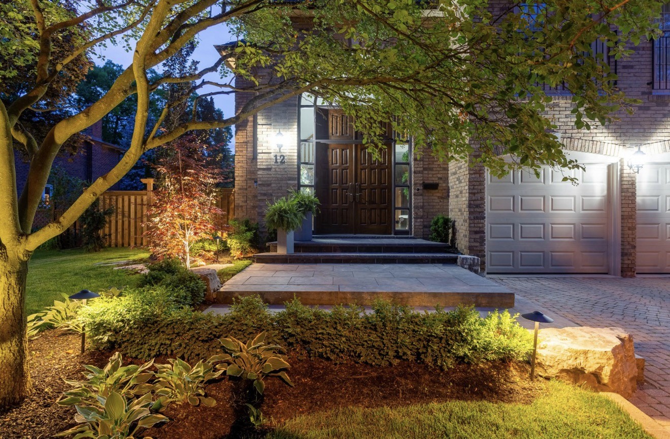 Front entrance with planting and warm outdoor lighting